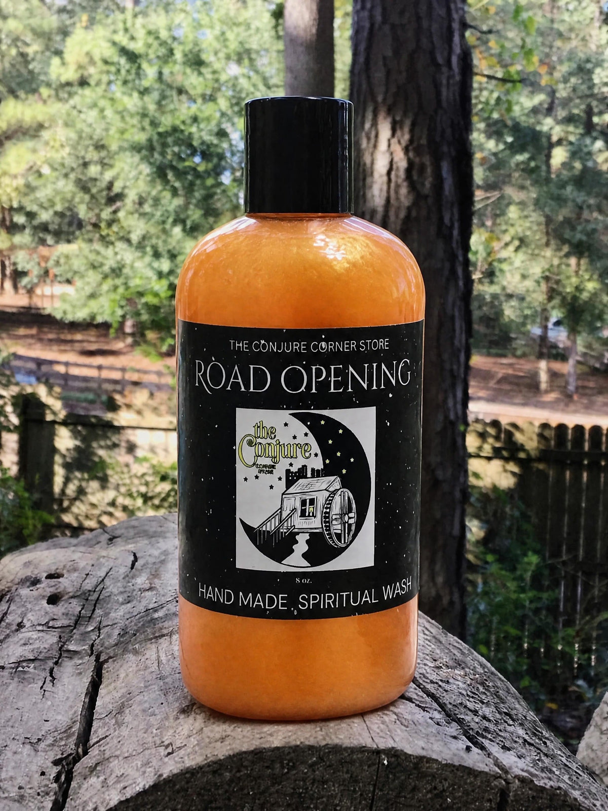 Road Opening spiritual wash bottle with label on a tree stump